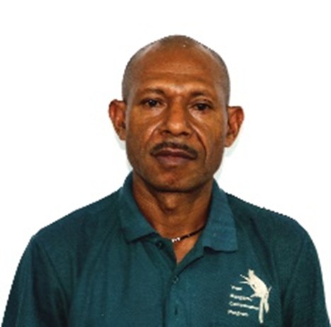 Steven Fononge. A man with short hair and a mustache wearing a teal collared shirt with the TKCP logo, standing against a plain white background.
