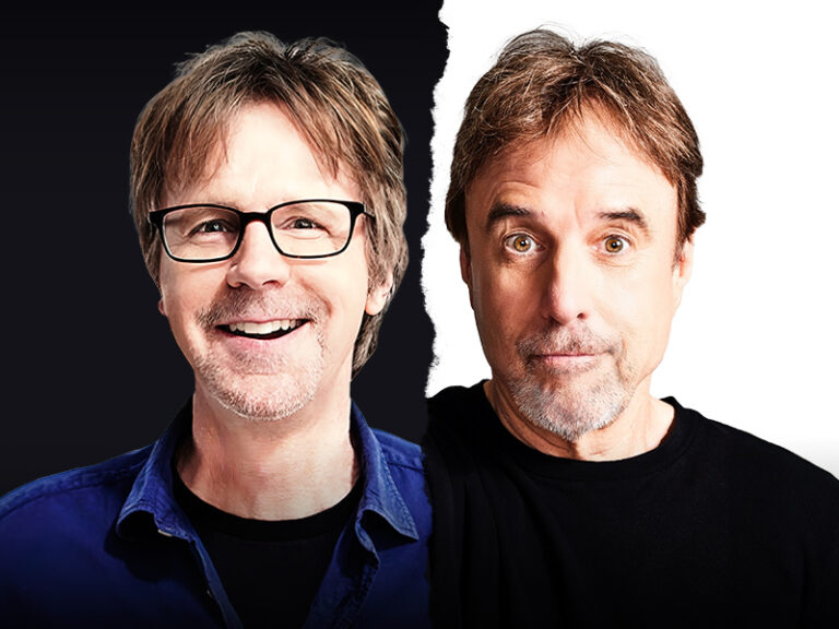 Two middle-aged men are pictured side by side, separated by a torn line. The man on the left has glasses, light brown hair, and a blue shirt, smiling. The man on the right has darker hair, no glasses, and a neutral expression, wearing black.